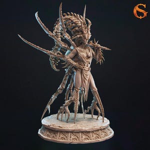 May include: A beige figurine of a humanoid alien with a skeletal design and multiple limbs. The figure is posed on a decorative base, holding a weapon. The image has a dark background and a logo in the top right corner.