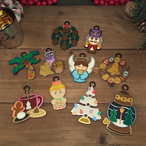 May include: Twelve Christmas ornaments with various themes, including a gingerbread man, a Christmas tree, a nutcracker, and a snow globe. The ornaments are made of felt and have a variety of colors, including red, green, blue, and gold.