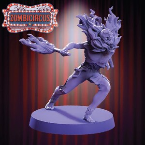 May include: A purple figurine of a zombie-like character in a dynamic pose, holding a flaming torch. The figure has a skull-like face and is wearing tattered clothing. The sign above the figure reads "ZOMBICIRCUS".