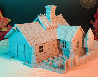 May include: A gray miniature cottage with a thatched roof, a chimney, and a small garden with a pumpkin. The cottage has a wooden door and windows, and the garden has a fence and a few plants.