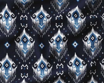 May include: A navy blue fabric with a white and blue geometric pattern. The pattern is a repeating design of diamonds and stylised figures.
