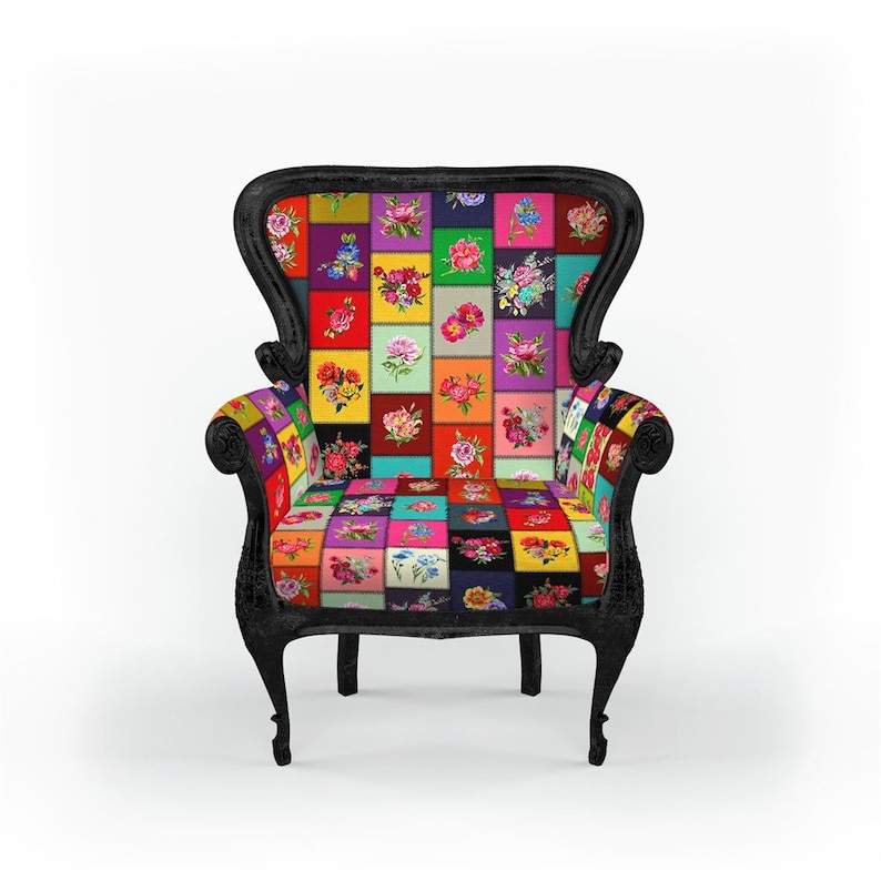 May include: A black armchair with a high back and ornate detailing. The seat and backrest feature a patchwork design of colorful floral squares. The chair has curved legs and armrests, creating a vintage aesthetic.