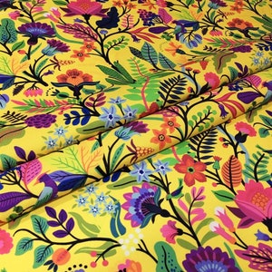 May include: Yellow fabric with a colourful floral pattern. The pattern features flowers, leaves, and birds in shades of pink, purple, blue, green, orange, and red.