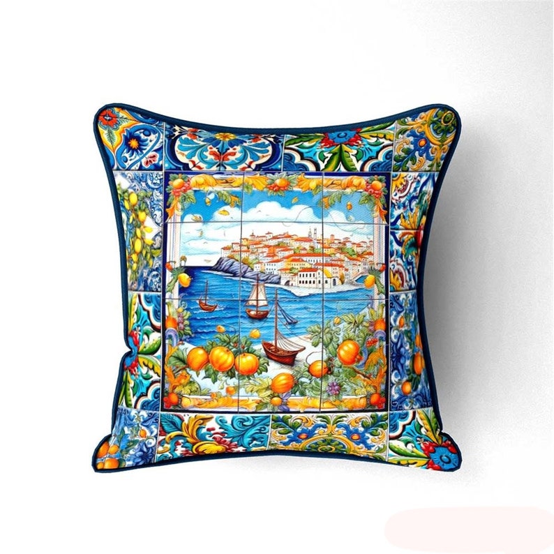 May include: A blue and white pillow with a colorful Italian tile design featuring a cityscape, boats, and lemons.