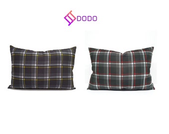 May include: Two decorative throw pillows with a black and white plaid pattern. One pillow has yellow accents and the other has red accents.