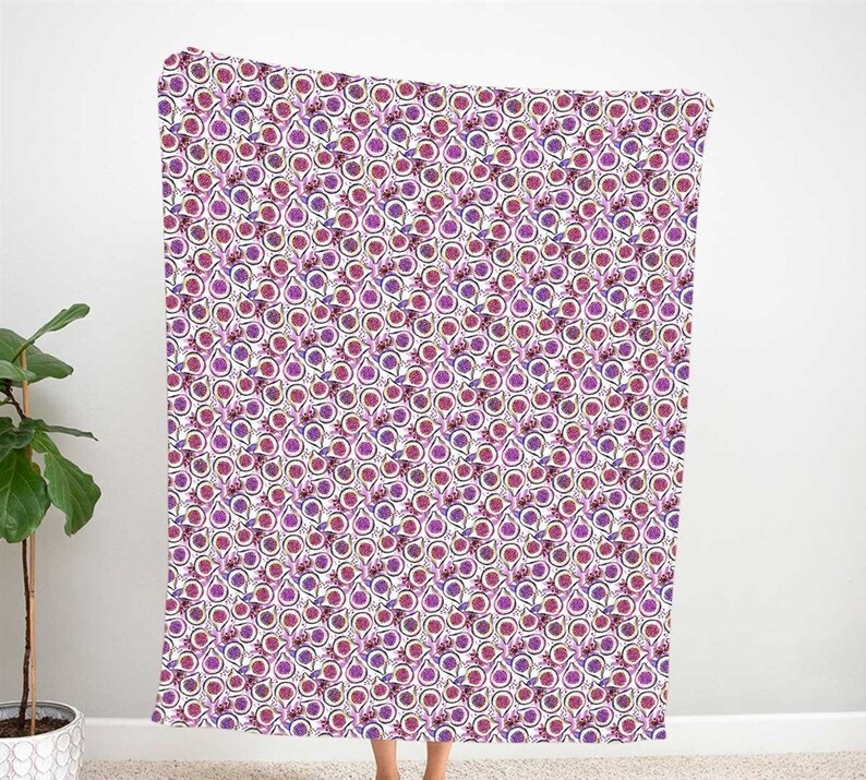 May include: A white throw blanket with a repeating pattern of purple and pink passion fruit. The fruit is surrounded by a black outline and a white background.