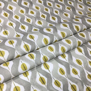 May include: Gray and yellow fabric with a geometric pattern of overlapping diamonds and leaves. The fabric has a subtle watercolor effect.
