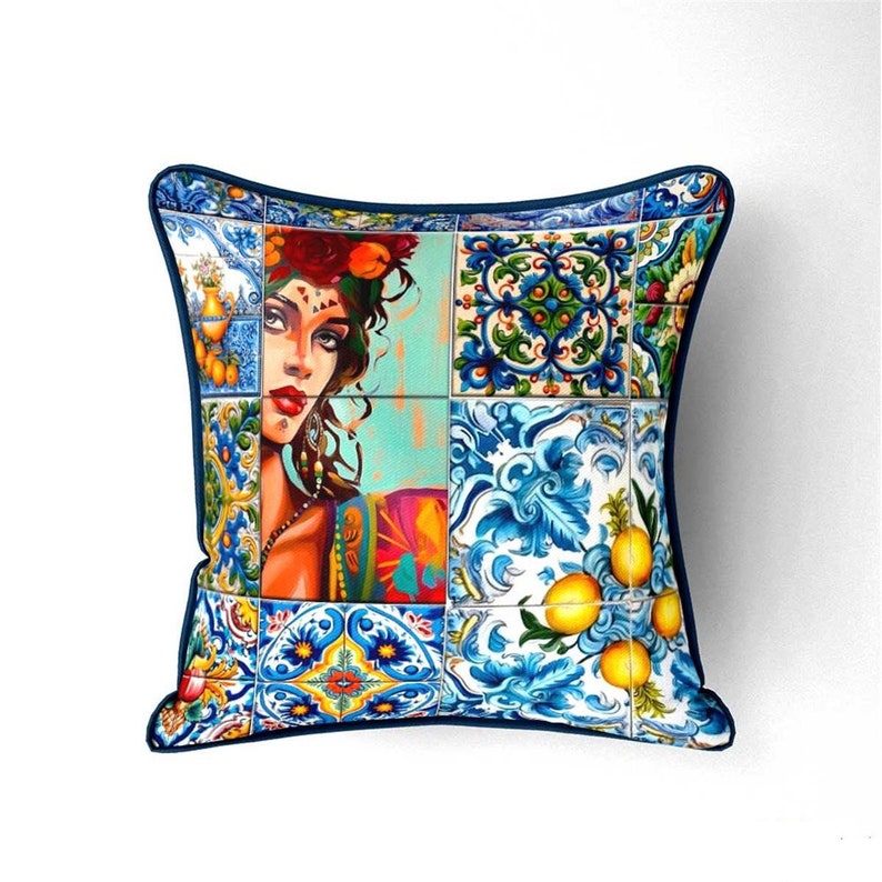 May include: A blue and white pillow with a colorful design of a woman's face and lemons. The design is reminiscent of traditional Portuguese tiles.