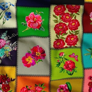 May include: A patchwork design featuring squares with floral patterns. The squares are in various colors, including green, yellow, and blue, and are stitched together with black thread. The floral designs include red peonies and other colorful flowers.