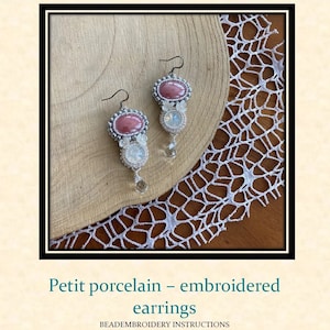 May include: A pair of pink and white beaded earrings with a porcelain stone. The earrings are hanging from silver hooks.