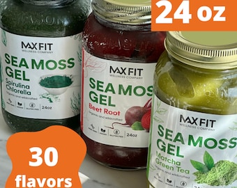 May include: Three glass jars of sea moss gel, each with a different flavor: spirulina chlorella, beet root, and matcha green tea. Each jar is labeled with the MaxFit Wellness Company logo and the text "Sea Moss Gel". The jars are 24 ounces each and are organic and wildcrafted. The jars are on a white marble surface. There is a text overlay that says "30 flavors" and "24 oz".