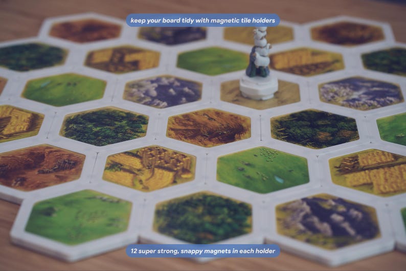 May include: A board game setup featuring hexagonal tiles held together by white magnetic tile holders. A small white game piece stands on one tile. Text on the image reads: keep your board tidy with magnetic tile holders and 12 super strong, snappy magnets in each holder.