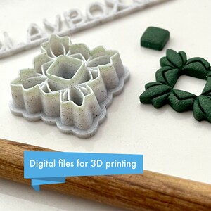May include: Two 3D printed cookie cutters, one white with a detailed floral design and one green with a square frame design. The text "Digital files for 3D printing" is visible on a wooden rolling pin.
