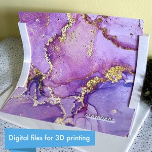 May include: A digitally printed artwork featuring a vibrant abstract design in shades of purple and gold. The artwork is displayed in a white frame. Text at the bottom reads "Digital files for 3D printing". The artwork is from CLAYBOX.CA.