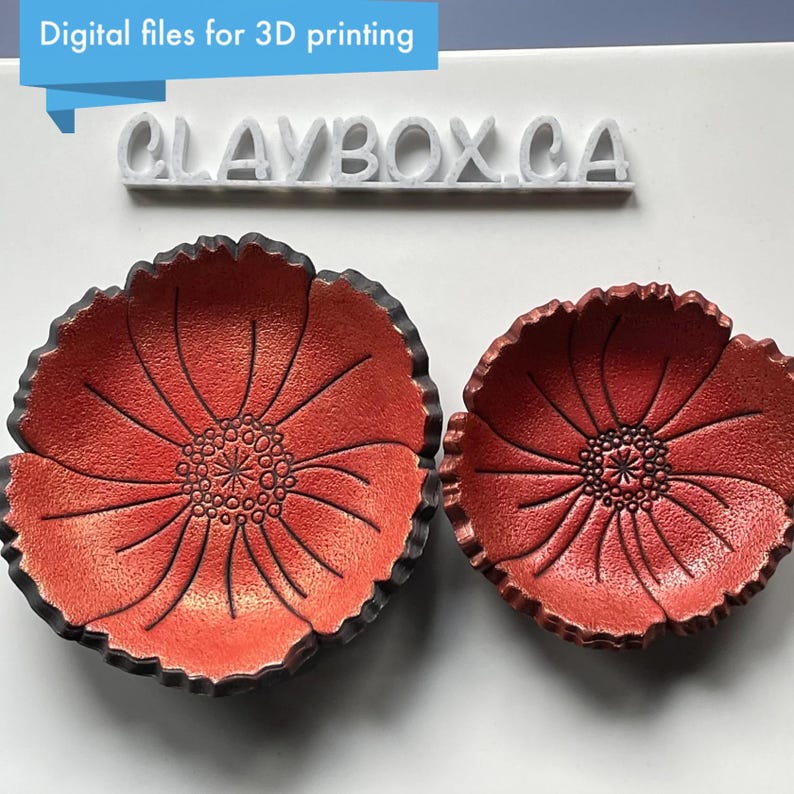 May include: Two red poppy-shaped bowls with black rims. The bowls have a textured surface and a detailed floral design. The text "Digital files for 3D printing" and "CLAYBOX.CA" are visible.