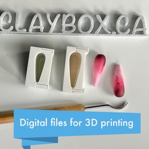 May include: Two white 3D printed molds for making teardrop-shaped polymer clay earrings. The molds are next to two pink and red teardrop-shaped earrings. The text "CLAYBOX.CA" is visible at the top of the image. The text "Digital files for 3D printing" is visible at the bottom of the image.