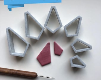 May include: A set of eight white plastic geometric shapes, including a variety of triangles and quadrilaterals, with two small pink clay shapes. The text "Digital files for 3D printing" is visible at the top of the image.