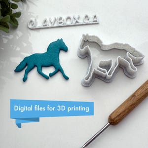 May include: A teal blue 3D printed horse figurine and a white 3D printed horse cookie cutter. The cookie cutter is slightly larger than the figurine. The text "CLAYBOX.CA" is printed on a white surface behind the objects. The text "Digital files for 3D printing" is printed on a blue banner.