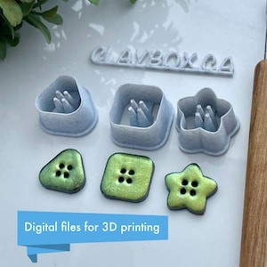 May include: Set of six 3D printed cookie cutters in the shape of a triangle, square, star, and flower. The cutters are white with a textured surface. There are also three green and gold buttons with four holes each.