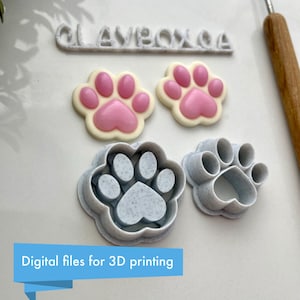 May include: Two 3D printed paw print cookie cutters, one with a detailed paw print and the other with a simple outline. Two pink paw print fondant decorations are also shown.