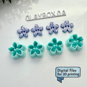 May include: An assortment of flower-shaped craft supplies. There are four blue and white flower-shaped buttons and four turquoise flower-shaped cutters. The text "Digital files for 3D printing" is in a blue banner.