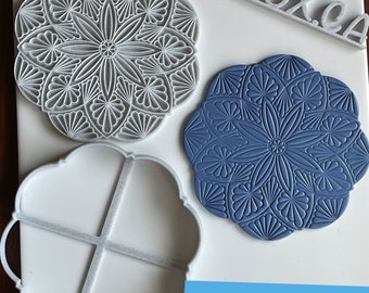 May include: Two 3D printed molds for making decorative cookies or fondant. One mold is white and the other is blue. Both molds feature a detailed floral design. The text "Digital files for 3D printing" is visible in the image.