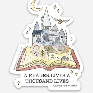 May include: A sticker featuring a watercolor illustration of a castle, a book, and stars. The text "A reader lives a thousand lives - George RR Martin" is printed below the illustration.