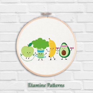 May include: A cross-stitch embroidery hoop featuring a playful design of anthropomorphic fruits and vegetables. An apple jumps rope, broccoli uses a hula hoop, a banana dances, and an avocado lifts weights. The text "Etamine Patterns" is at the bottom.