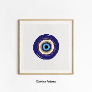May include: A blue evil eye with concentric circles of white, gold, and light blue. The evil eye is a symbol of protection against bad luck and envy.