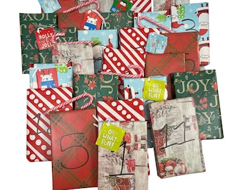 A pile of books that are wrapped in Christmas paper with numbers on each of them. There are candy canes scattered about as well.