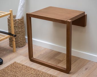 Silla de pared plegable y compacta para espacios pequeños