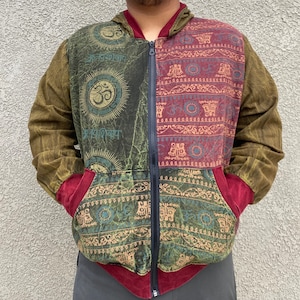 May include: A green, red and brown patterned zippered hoodie with a hood. The hoodie features a variety of symbols and designs, including a large Om symbol.