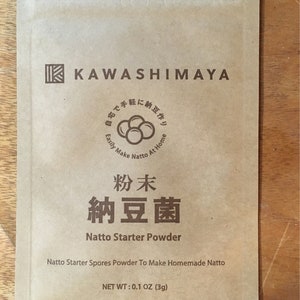 May include: A brown paper pouch with the text "KAWASHIMAYA" and "Natto Starter Powder" printed on it. The pouch contains a powder to make homemade natto, a fermented soybean dish. The text "宅で手軽に納豆作り" is also printed on the pouch, which translates to "Easily make natto at home". The pouch has a net weight of 0.1 oz (3g).