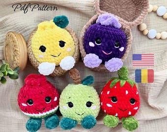 May include: Five plush crochet toys shaped like fruits, including a yellow lemon, purple grape, red watermelon, green apple, and red strawberry. Each toy features black safety eyes, a stitched smile, and small limbs. Text reads Pdf Pattern.