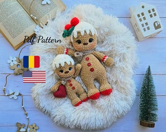 May include: Two crocheted gingerbread man dolls, one large and one small, rest on a fluffy white surface. The larger doll has a scarf, red buttons, and a decorative hat. The smaller doll holds a red heart. The text "Pdf Pattern" is visible.