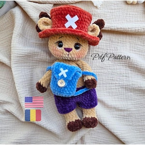 May include: A handmade plush toy of a cartoon character, with a red hat featuring a white cross, a blue backpack, and purple shorts. The toy is beige, with brown accents and a purple nose. The text "Pdf Pattern" is visible.