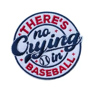 May include: Embroidered patch with the text "THERE'S no Crying in BASEBALL" in red and navy blue. The patch is circular with a baseball graphic in the center. The patch has a white background.