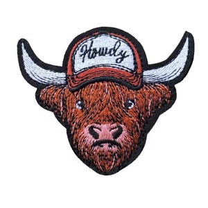 May include: Embroidered patch featuring a brown Highland cow wearing a red and white cap. The cap has the word "Howdy" embroidered on it in a cursive font. The patch has a black border and white horns.