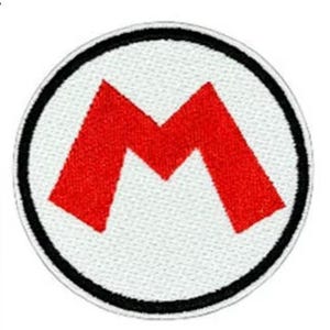 May include: Embroidered patch featuring a red "M" inside a white circle, outlined with a black border. The patch is likely for clothing or accessories, representing a popular video game character.