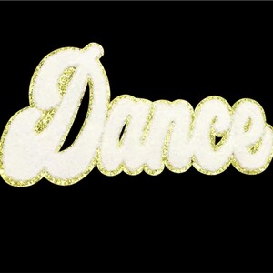 May include: White, fluffy "Dance" applique with gold glitter trim, set against a black background. The word is in a cursive font, perfect for dance-themed crafts or apparel.