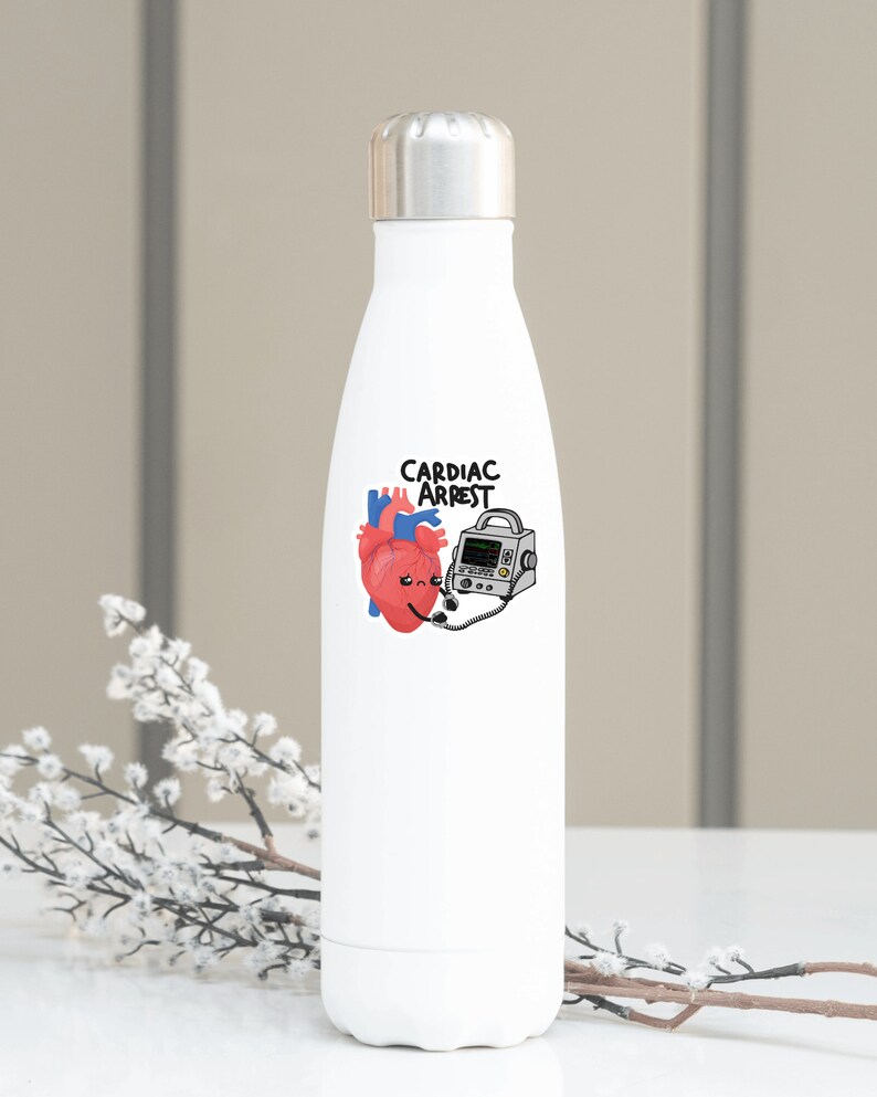 May include: White stainless steel water bottle with a cartoon heart and a defibrillator with the text "Cardiac Arrest" printed on it.