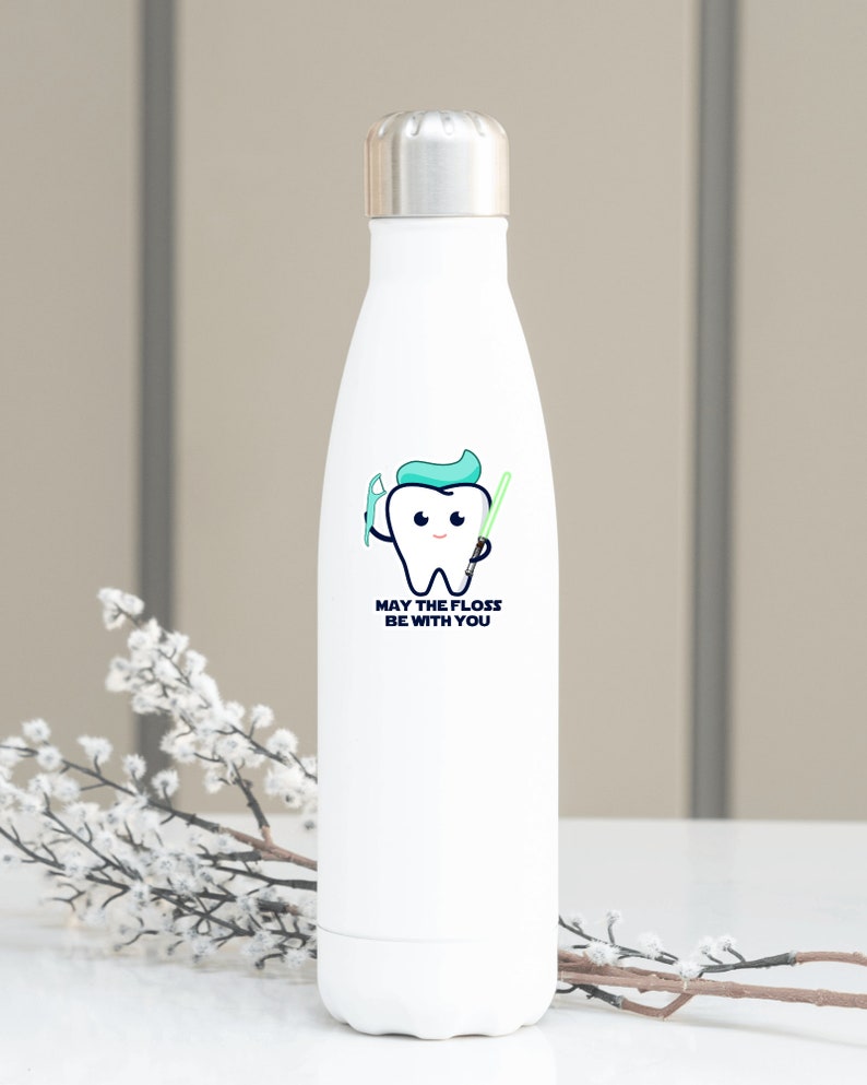May include: White stainless steel water bottle featuring a cartoon tooth holding a toothbrush and a lightsaber. The text on the bottle reads "May the floss be with you."