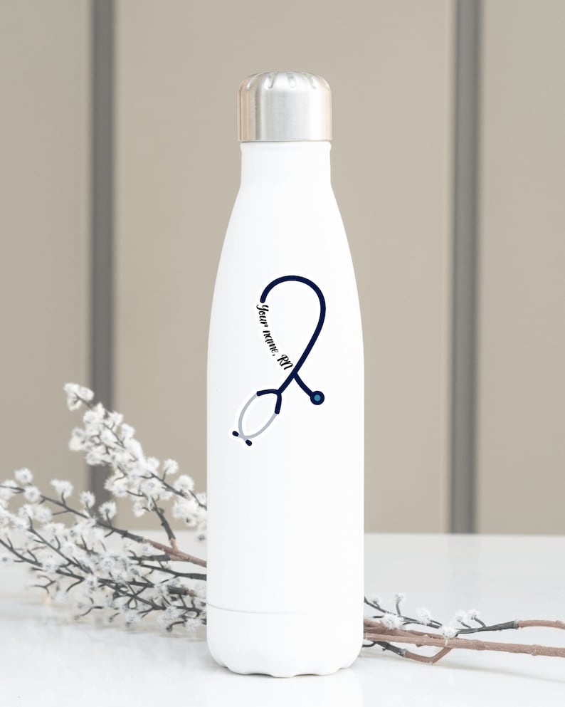 Puede incluir: Botella de agua de acero inoxidable blanca con un dise&ntilde;o de estetoscopio azul y el texto "Your name, RN".