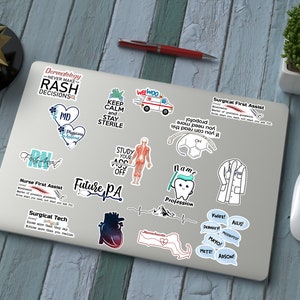 May include: A laptop computer covered in stickers with various medical professions and sayings. The stickers are in blue, green, pink, and white. The stickers include "Dermatology Never Make Rash Decisions", "Keep Calm and Stay Sterile", "Future PA", "Nurse First Assist", "Surgical Tech", "Surgical First Assist", "I am a Profession", and more.