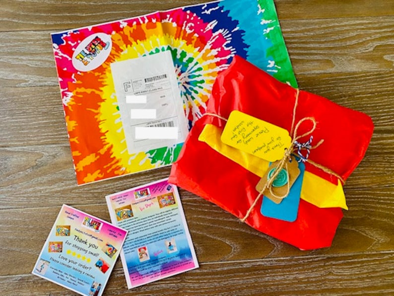 May include: A red, yellow, and blue gift wrapped in brown twine with a handwritten note that says "exception my very 1st gift from mommy!" and a tag that says "weekend trip so much fun!"