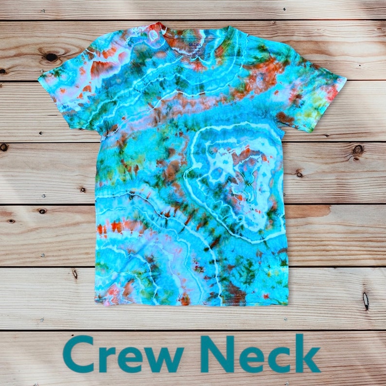 May include: A blue tie-dye t-shirt with orange, green, and white accents. The shirt has a crew neck and short sleeves.