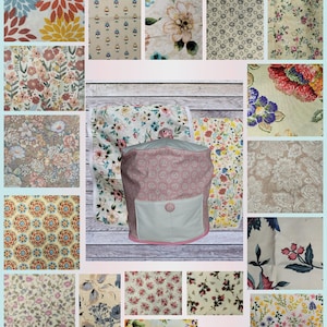 May include: A collection of floral fabric swatches in various patterns and colors, including blooms in orange, blue, and pink. A pink and white patterned storage bag with a white pocket and pink trim is in the center.