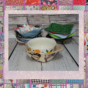 May include: A set of four fabric bowl covers in various patterns, including green with white polka dots, blue with white flowers, and red with white stars. The covers are displayed on a wooden surface with a white ceramic bowl in the center.