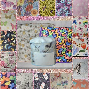 May include: A collection of fabric swatches and a round object, all featuring butterfly patterns. The swatches showcase various colors and designs, including floral, abstract, and animal prints. The round object has a light blue base with a white pocket and a button.