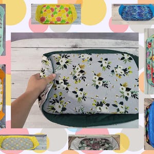 May include: A collection of 10 different fabric-covered trays with various patterns, including floral, fruit, and geometric designs. The trays are all rectangular and have a green, yellow, or blue border.